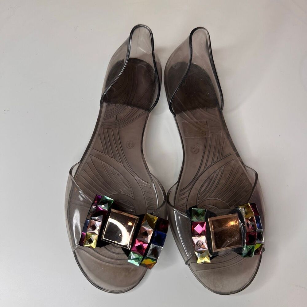 jelly flat sandals in a translucent smoke-gray color featuring large decorative